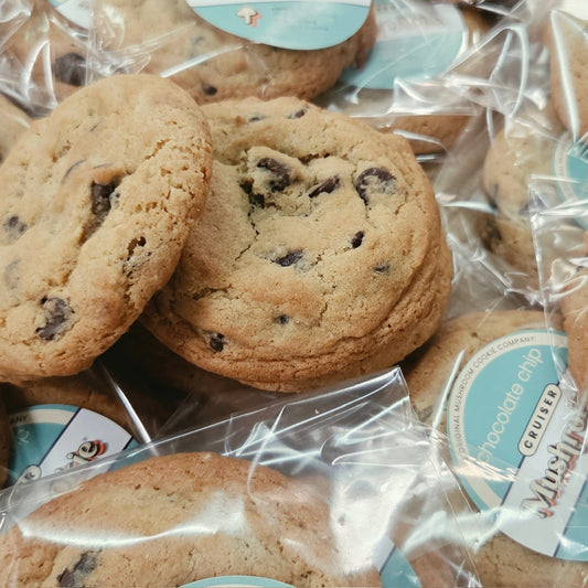Chocolate chip cookies individually wrapped in clear cellophane bags with round light blue and white labels reading 'Cruiser Chocolate Chip.'
